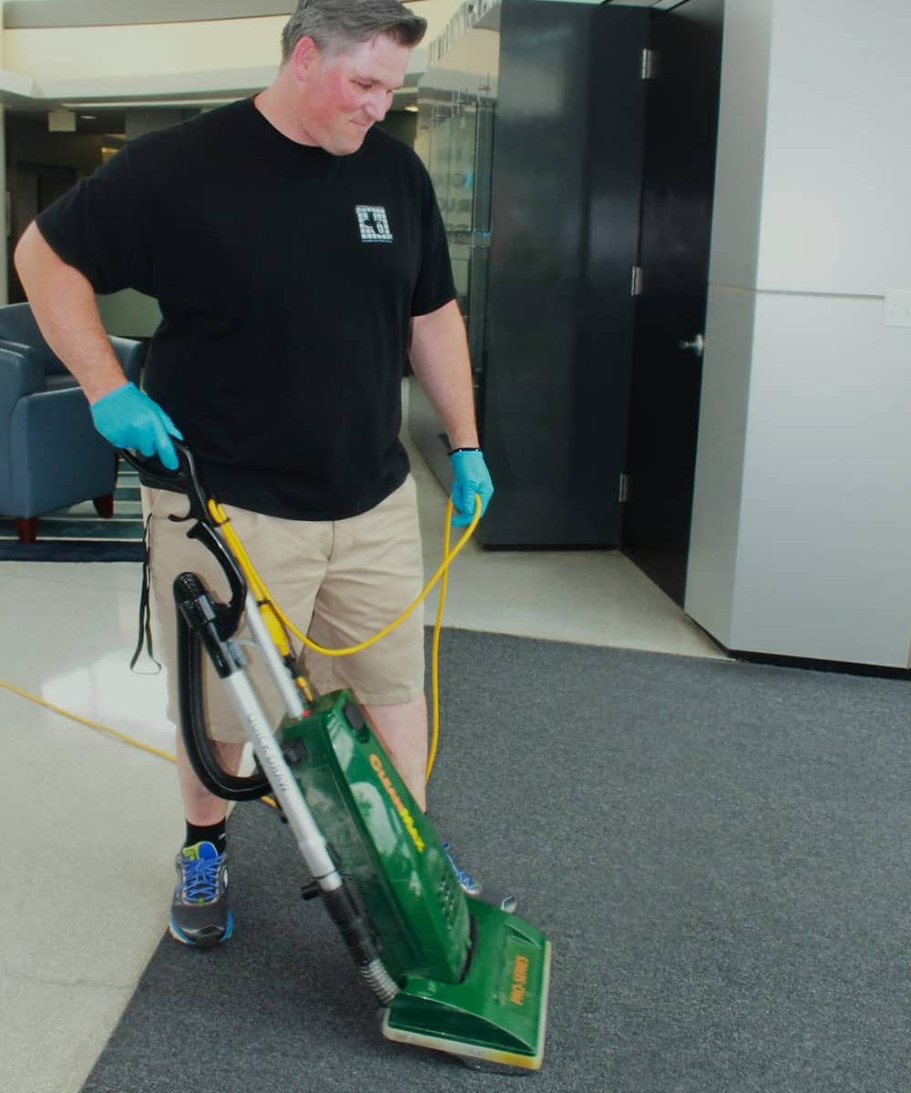 Jeffries cleaning professional in black shirt vacuuming floor