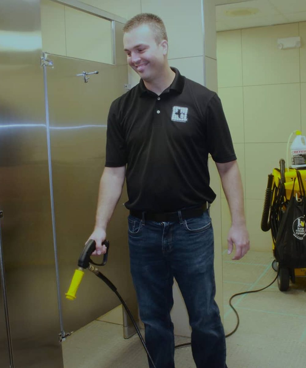 Jeffries Cleaning professional spraying bathroom floor