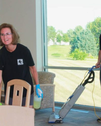 Jeffries Cleaning professionals vacuuming and wiping down tables