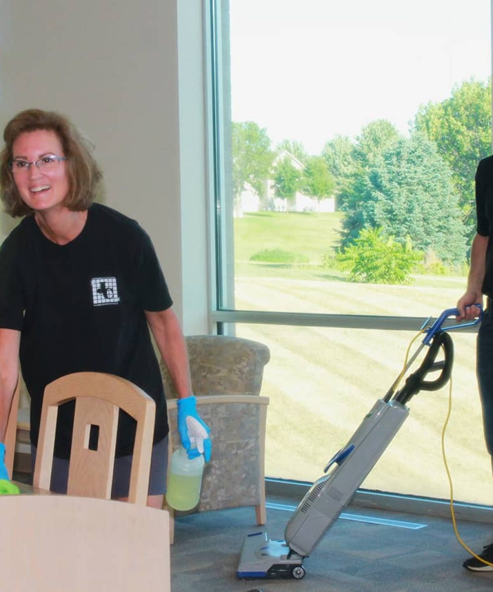 Jeffries Cleaning professionals vacuuming and wiping down tables